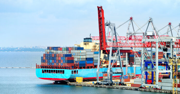 View on trading seaport with cranes, cargoes and the ship